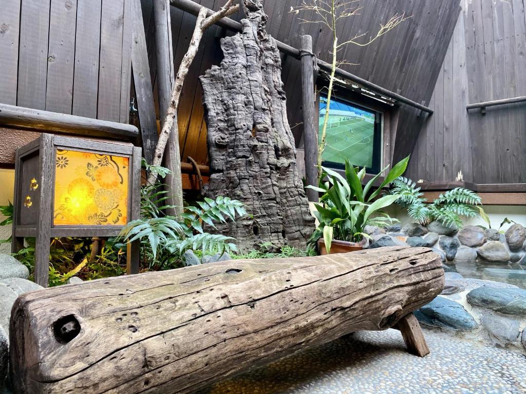 a log bench sitting in front of a building at Dormy Inn Akihabara in Tokyo