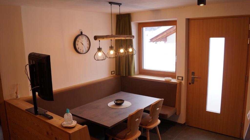 a dining room with a table and a television at Apartments Salieta in Santa Cristina in Val Gardena
