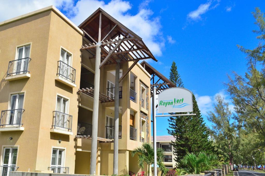 a building with a sign in front of it at Paradya Beach Apartments in Flic-en-Flac