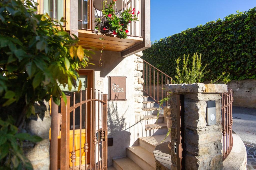 a house with a gate and a balcony with flowers at Borgo Cantagallo Casa Olivia 1 in Tremosine Sul Garda