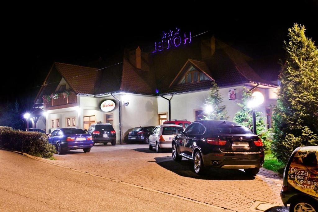 a group of cars parked in front of a hotel at Hotel Zalesie in Bochnia
