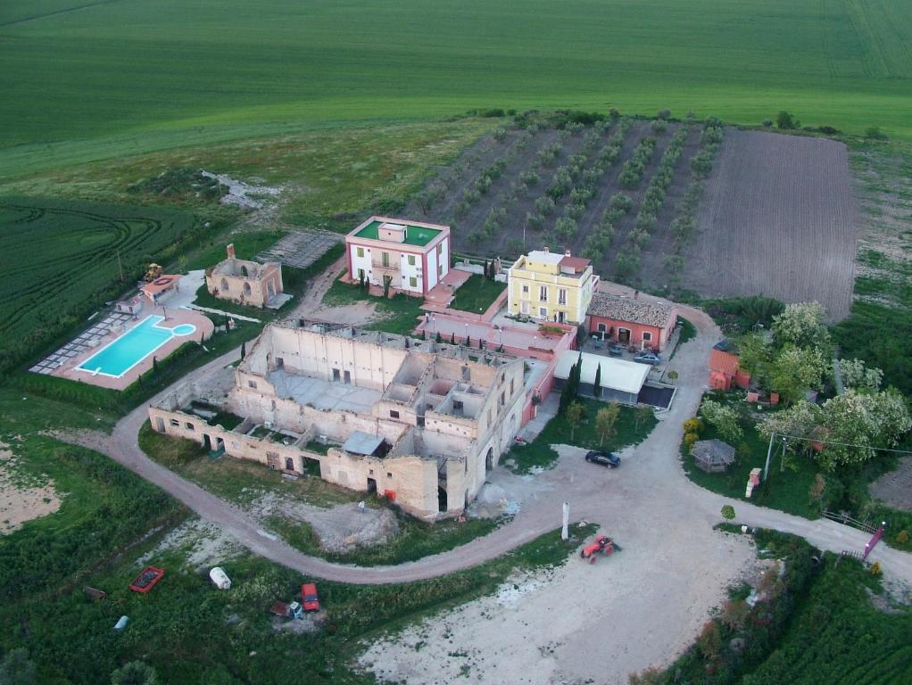 an aerial view of a large house with a pool at Masseria Sant'Agapito in Lucera