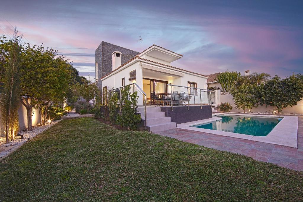 a house with a swimming pool in the yard at Modern Villa close to Costabella beach in Marbella