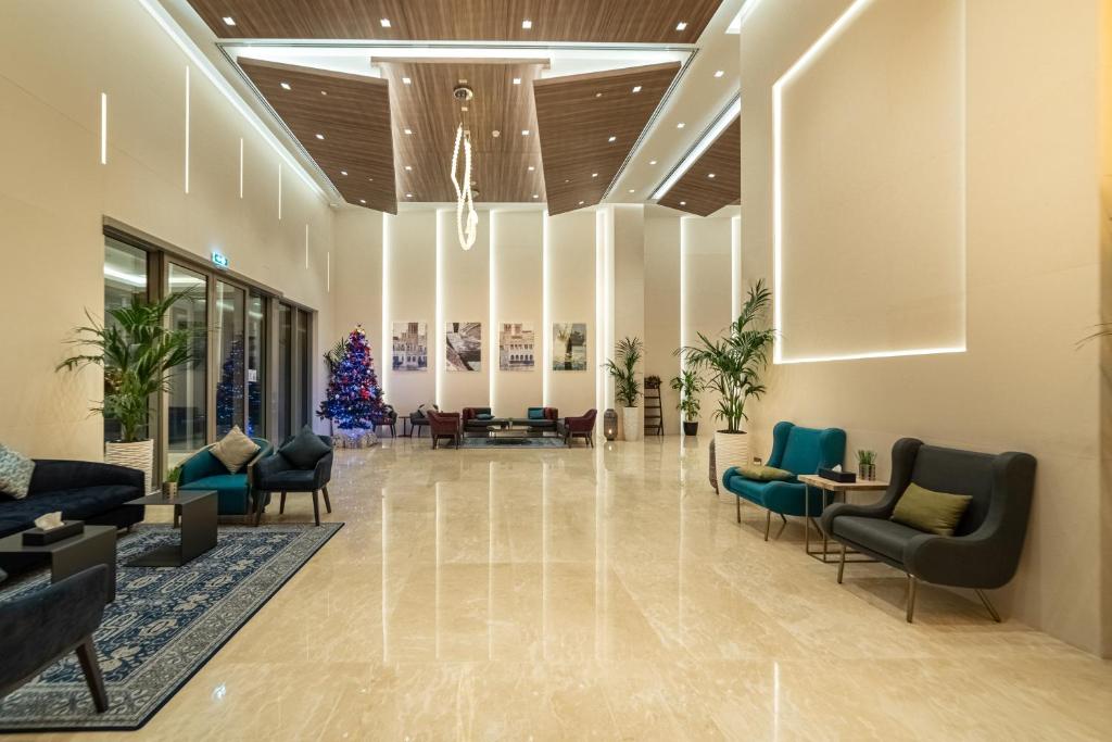a lobby with chairs and a christmas tree at Suha Mina Rashid Hotel Apartments in Dubai