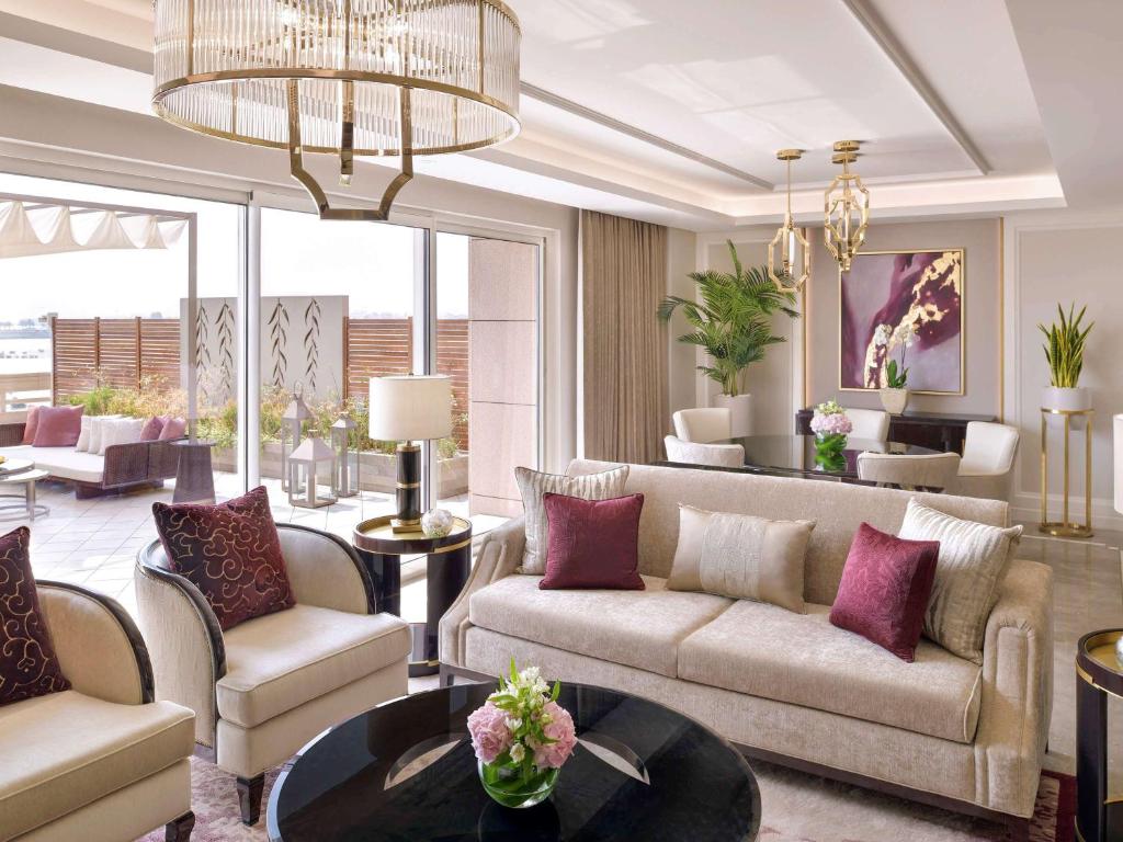 a living room with a couch and a table at Mövenpick Hotel Bahrain in Manama