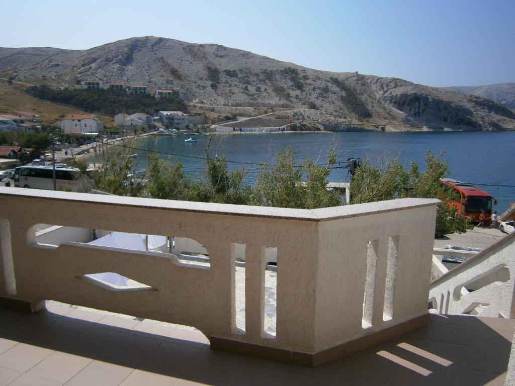 a balcony with a view of a body of water at Apartments Katica in Metajna