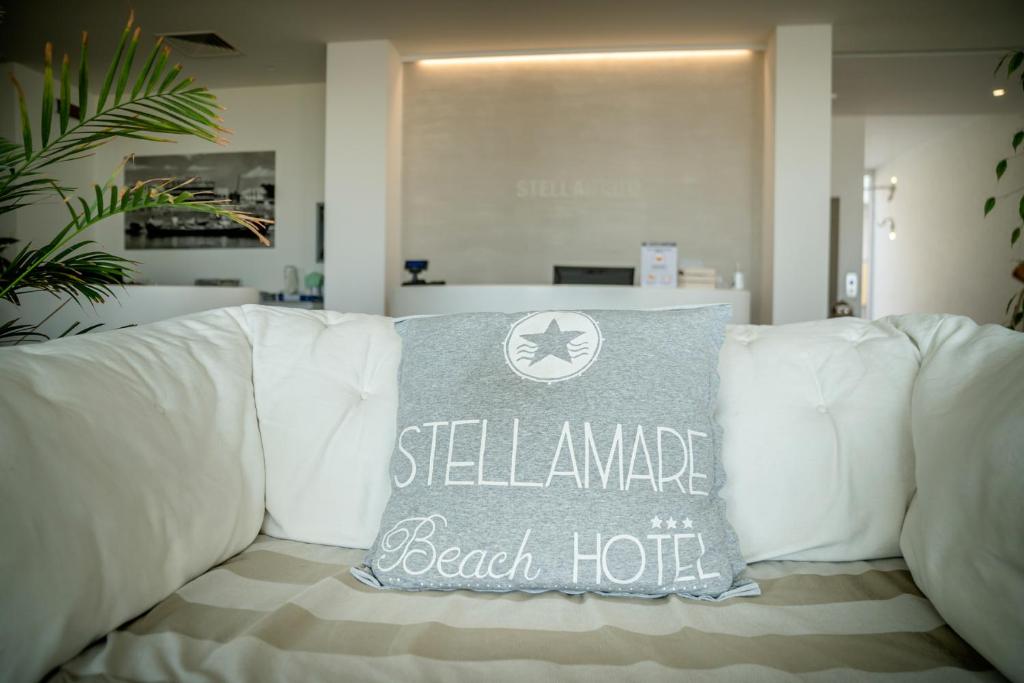 a pillow on a white couch in a living room at Stellamare in Caorle