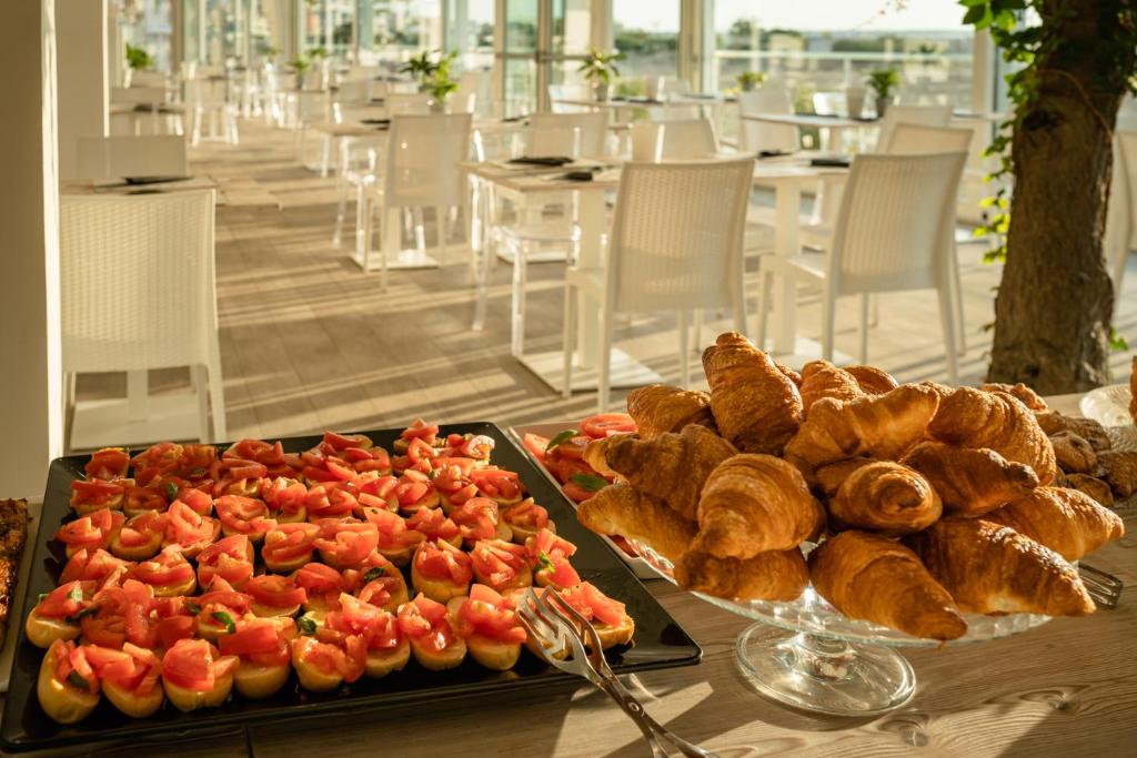 a table with a tray of bread and pastries at Stellamare in Caorle