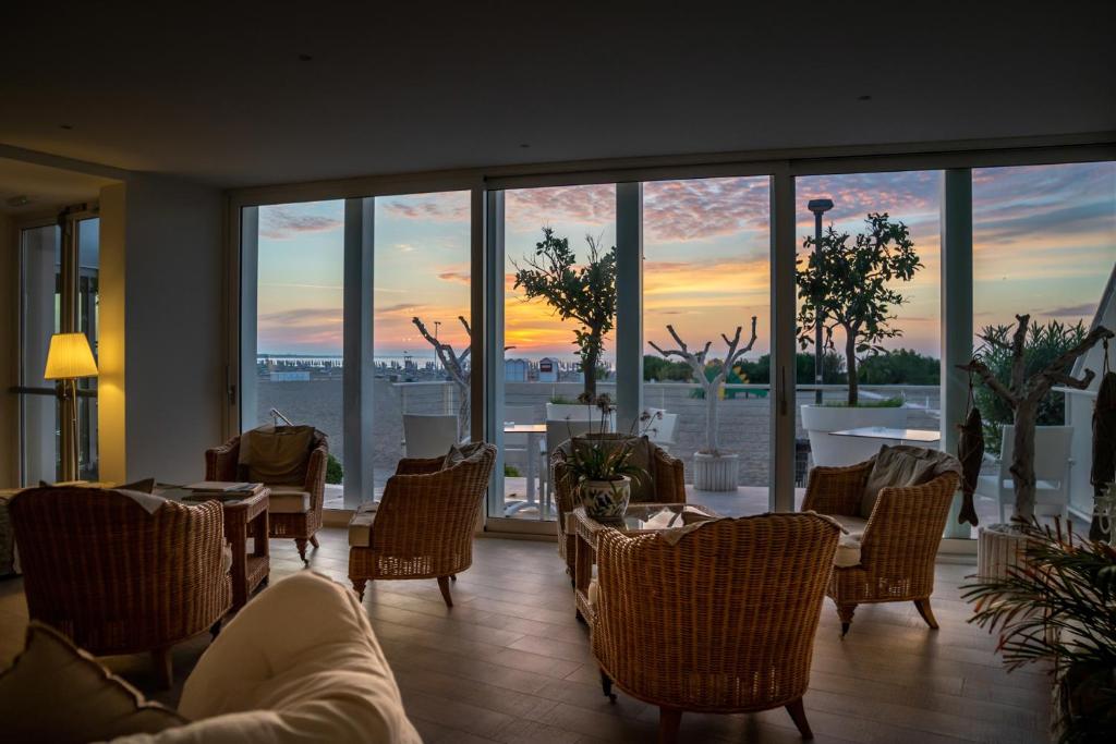 a restaurant with tables and chairs and a view of the sunset at Stellamare in Caorle