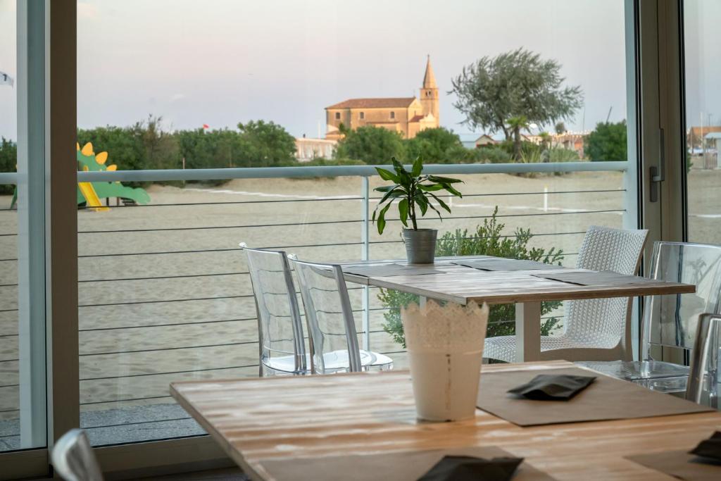 a table with a potted plant on top of a balcony at Stellamare in Caorle