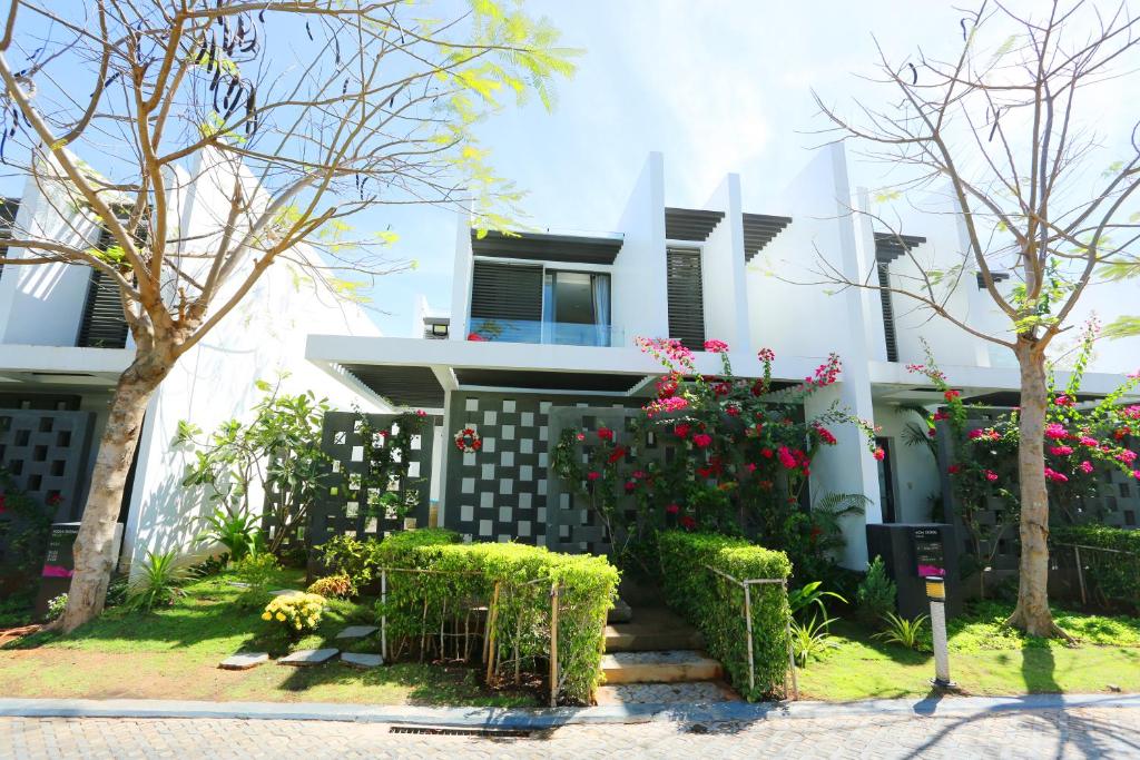 a house with flowers in front of it at Oceanami Resort in Long Hai