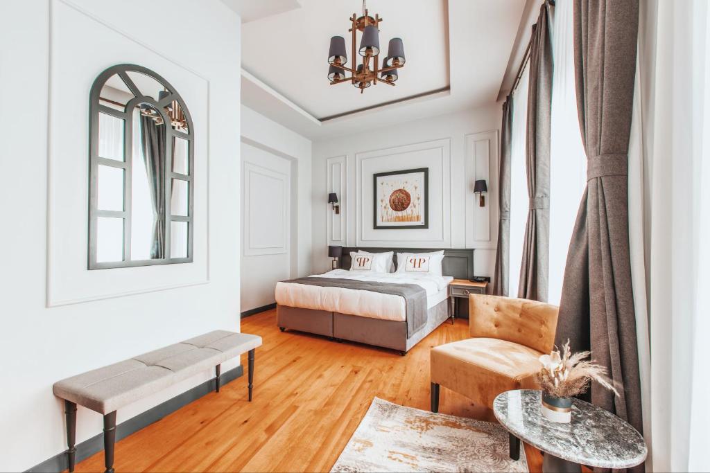 a bedroom with a bed and a living room at Ferman Port Hotel - Special Category in Istanbul