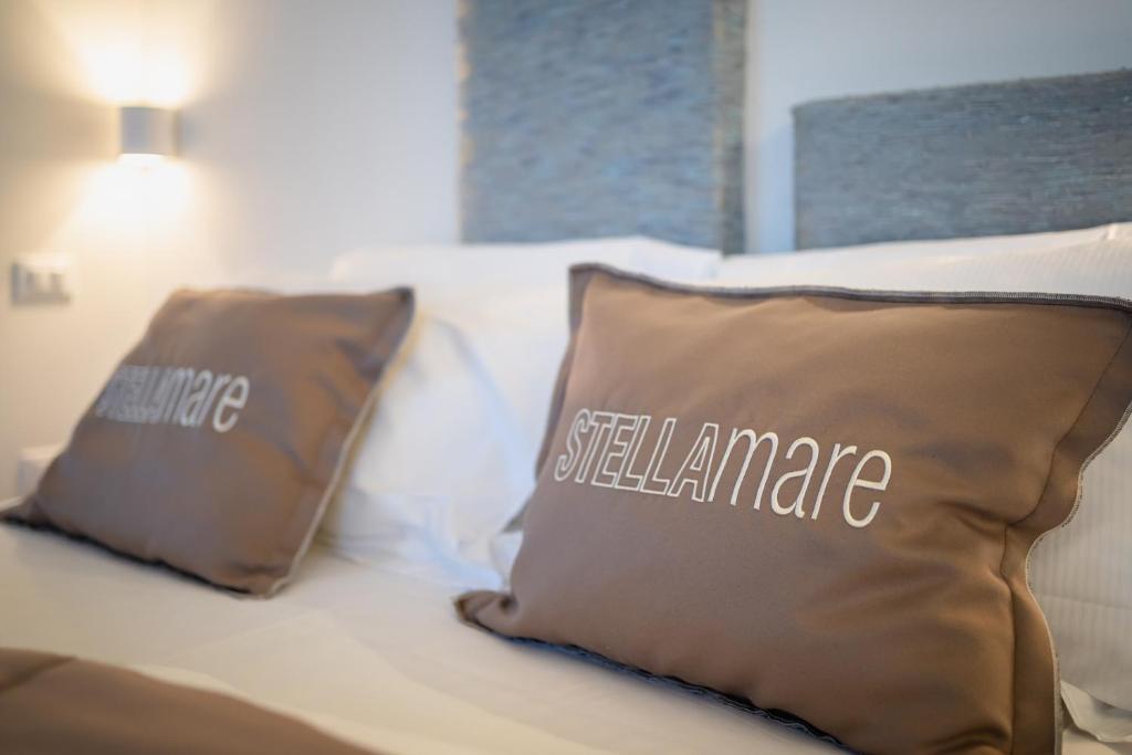a bed with two pillows on top of it at Stellamare in Caorle