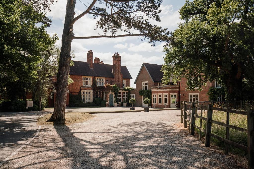 a house with a tree in the middle of a driveway at Pontlands Park Hotel in Chelmsford