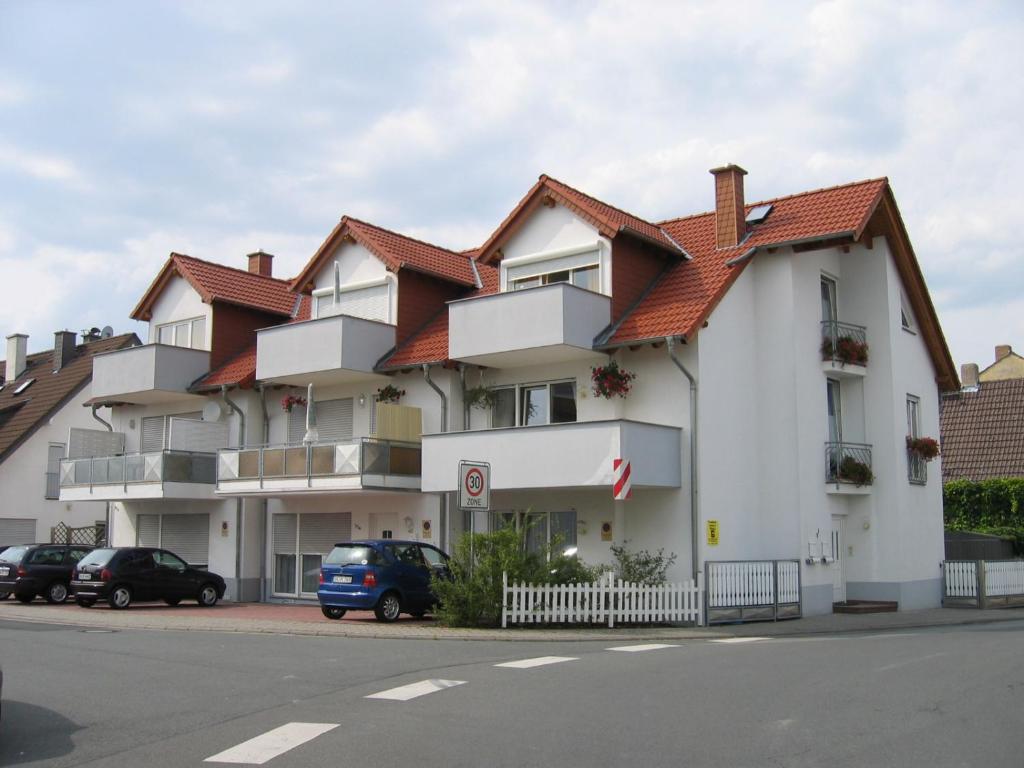 a large white building with a red roof at Pension Nickel Marktstraße 11 Alsbach-Hähnlein in Alsbach-Hähnlein