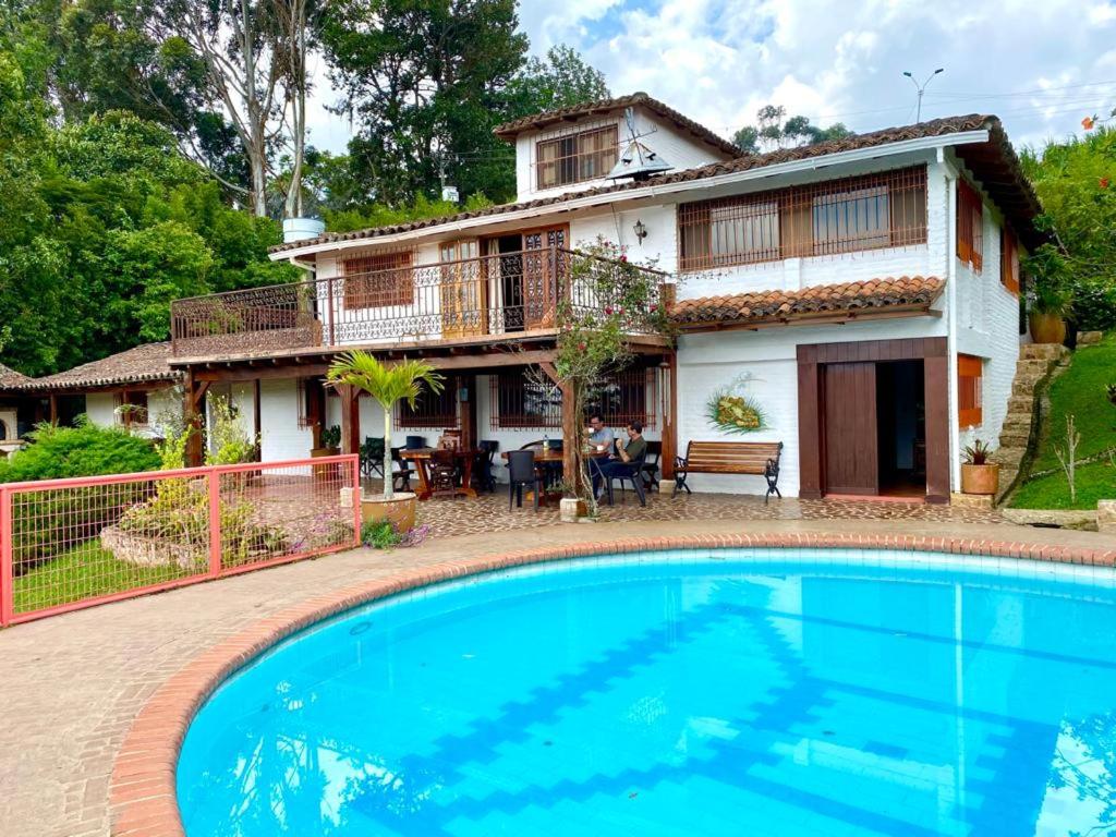 a house with a swimming pool in front of a house at Increíble finca en felidia in Cali