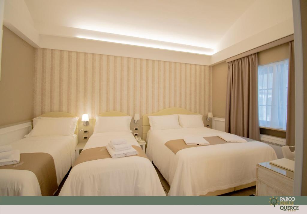 Postel nebo postele na pokoji v ubytování Hotel Parco delle Querce