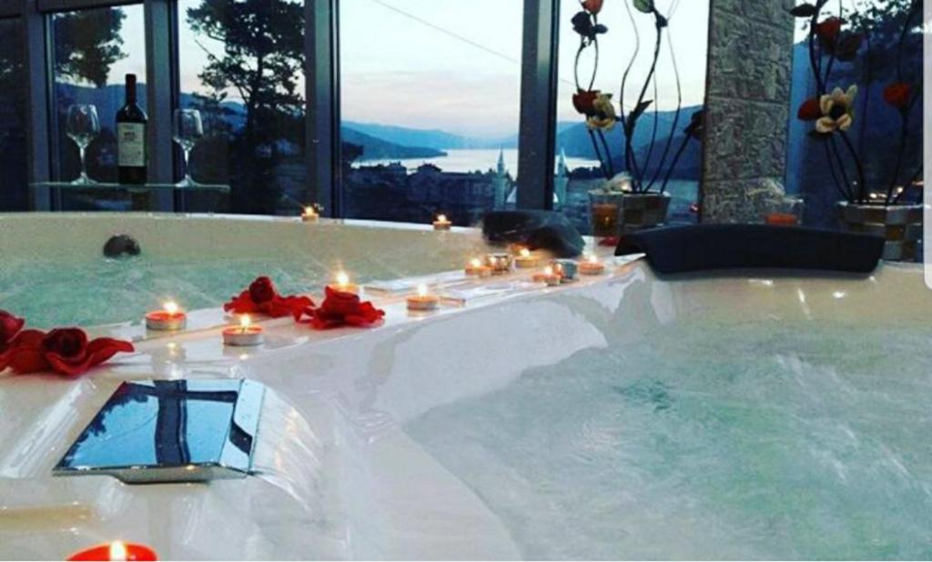 a bath tub with candles and candles at Safi in Dospat