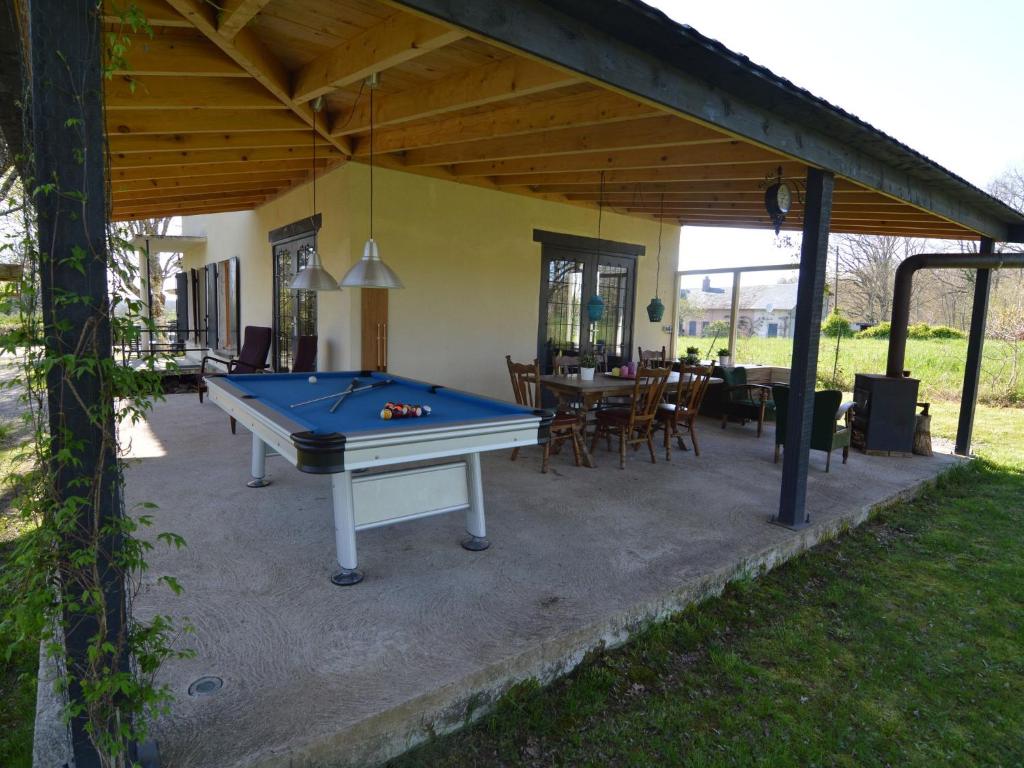 a patio with a pool table in a house at Modern Holiday Home in St Honor Les Bains near Forest in Saint-Honoré-les-Bains