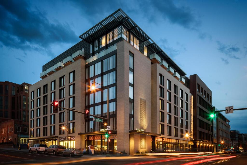 a large building on a city street at night at The Maven Hotel at Dairy Block in Denver