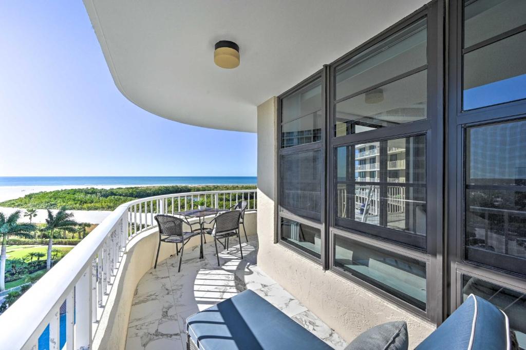 a balcony with chairs and a view of the ocean at Resort Condo with Balcony and Stunning Ocean Views! in Marco Island
