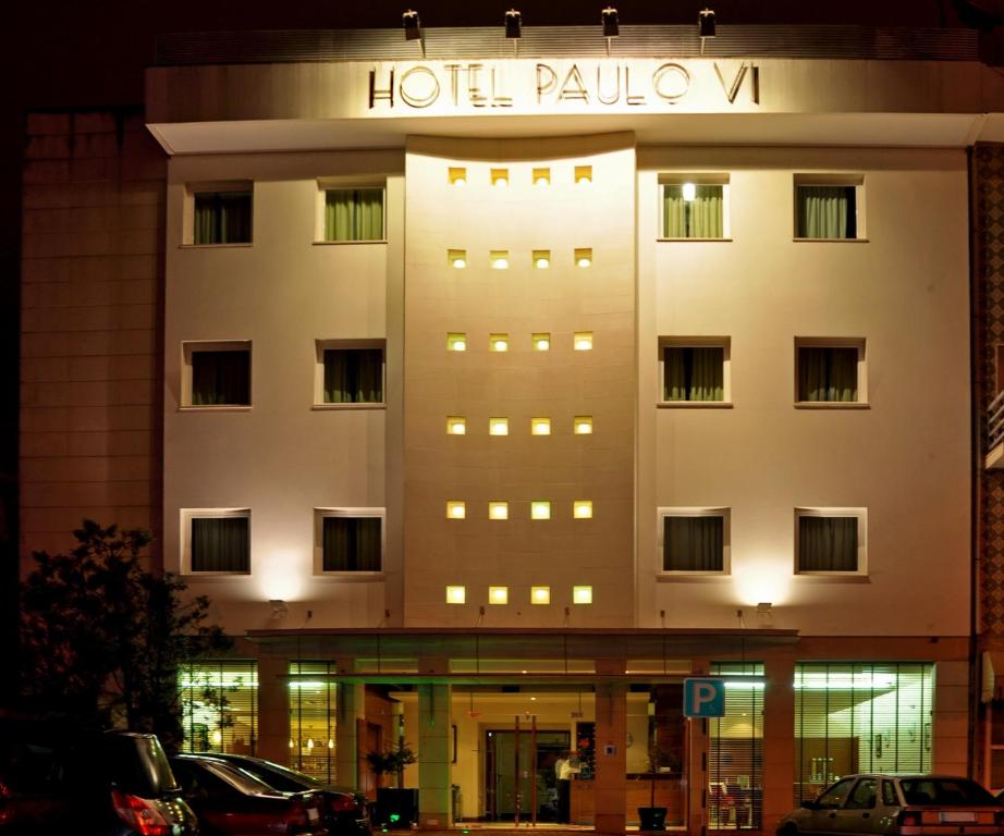 a hotel building with a sign on the side of it at Hotel Paulo VI in Rio Maior