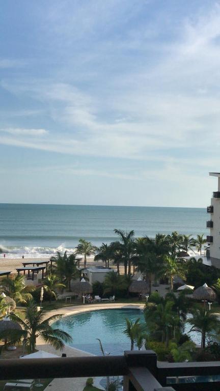 a view of the beach from the balcony of a resort at Playa Caracol Beachfront Residence Club in Chame