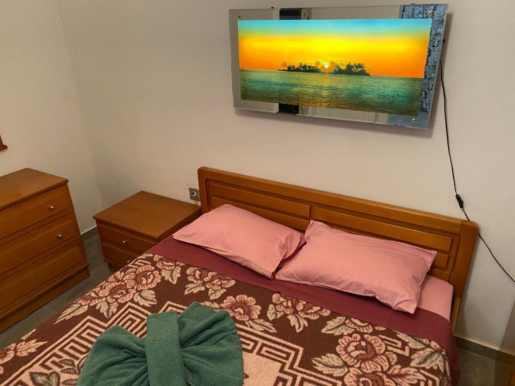 a bedroom with a bed and a tv on the wall at Jordans appartment in Thessaloniki