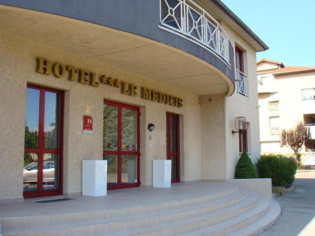 a hotel entrance with stairs in front of a building at Le Médicis in Roussillon en Isere