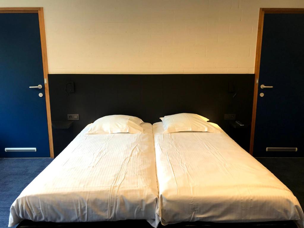 Postel nebo postele na pokoji v ubytování Vakantiedomein Hoge Duin