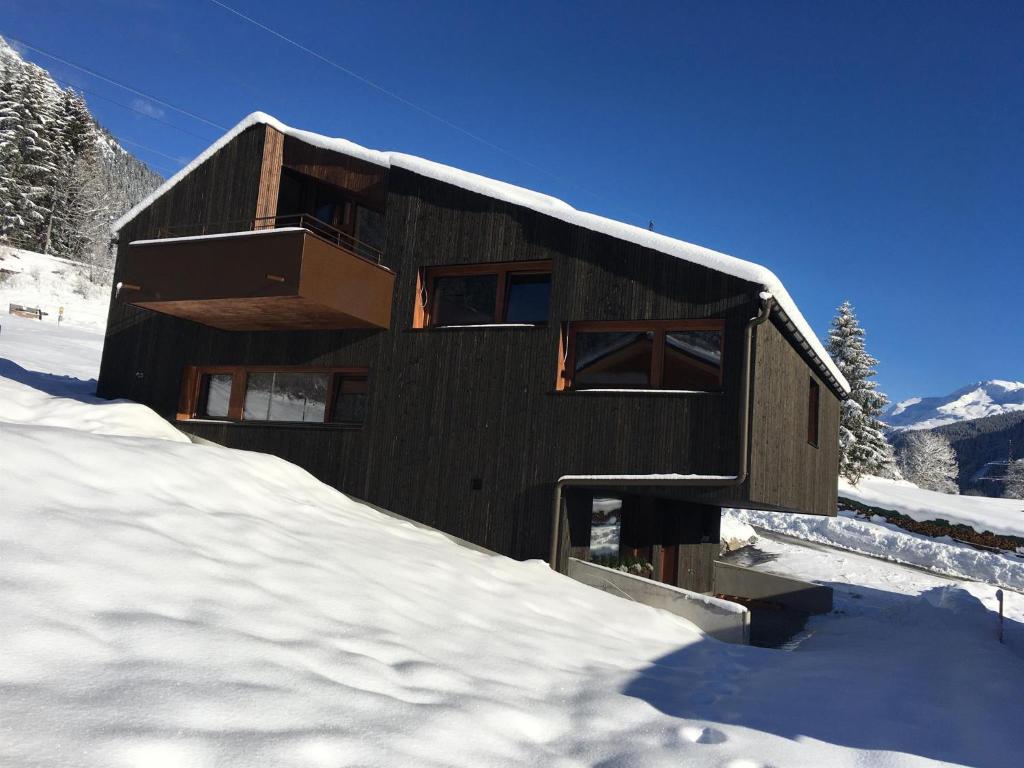 a building covered in snow in the snow at Apartment Hoamelig in Wald am Arlberg