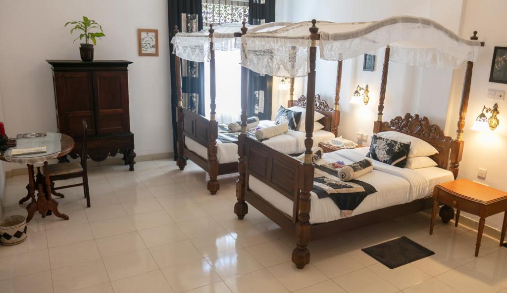 Postel nebo postele na pokoji v ubytování Manor House-Kandy