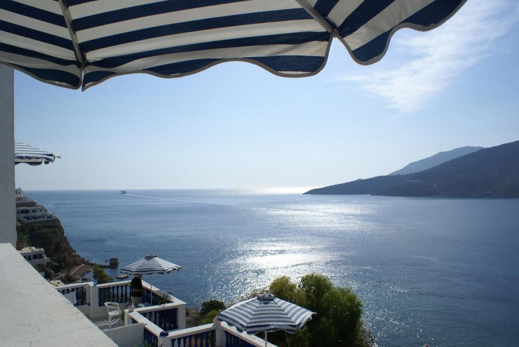 a view of a large body of water with an umbrella at Annas Studios in Livadia