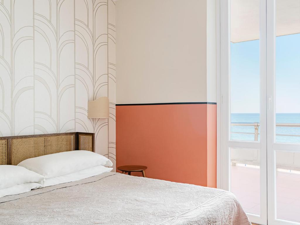 Postel nebo postele na pokoji v ubytování Hotel Riviera