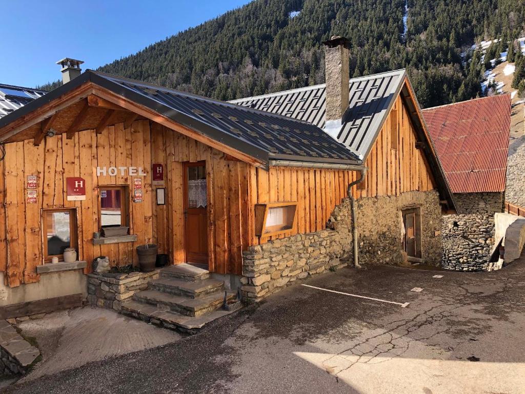 a large wooden building in the middle of a mountain at Auberge De La Foret in Auris