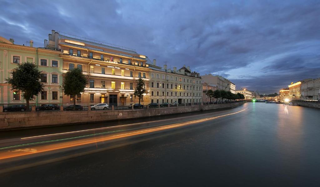 a city street with buildings and a river at night at Domina St.Petersburg in Saint Petersburg