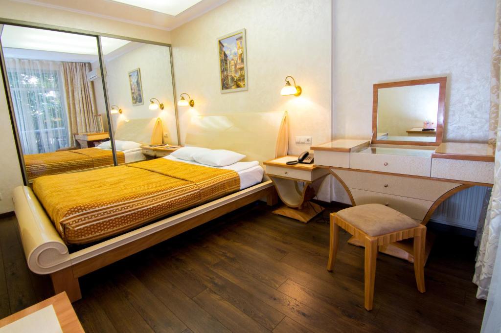 Postel nebo postele na pokoji v ubytování Residence Odesskij Dvorik