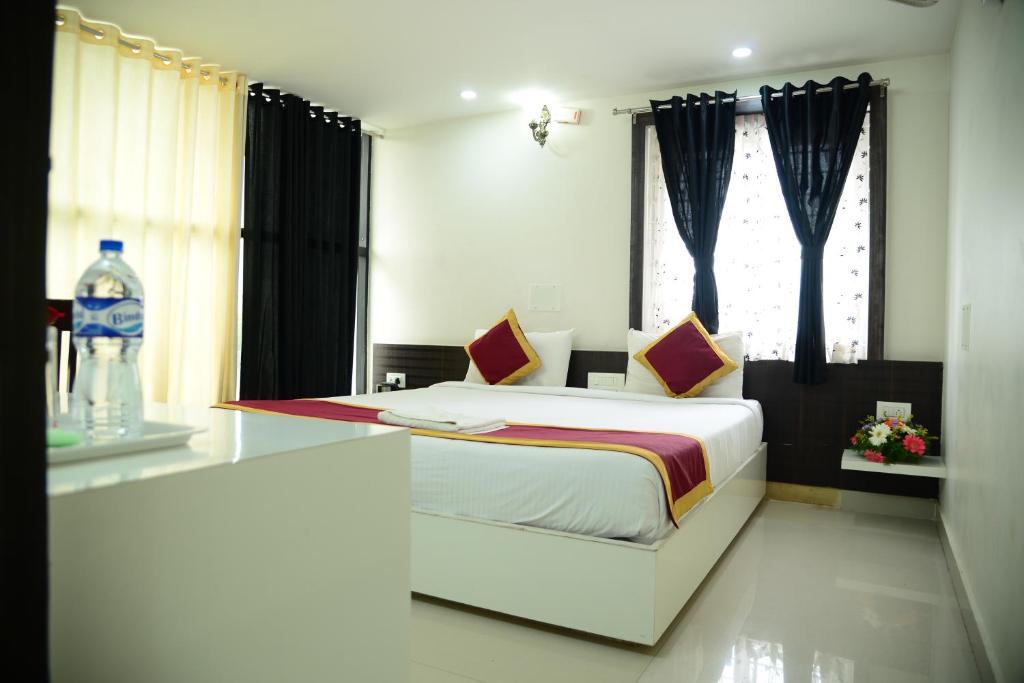 a bedroom with a white bed and a window at Miles Inn Hotel in Hassan