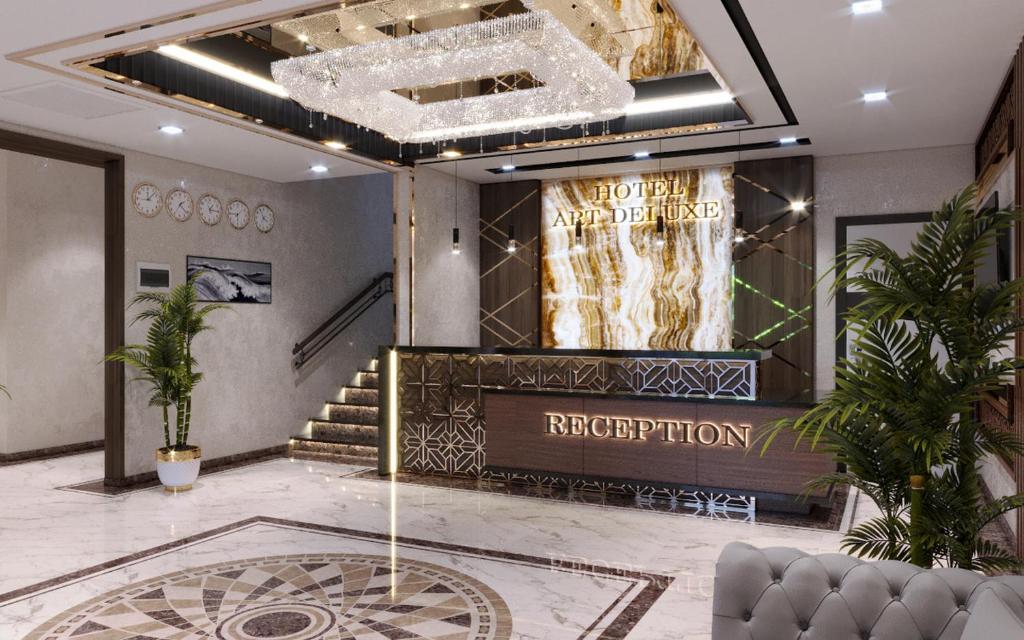 a lobby with a staircase and a chandelier at Art Deluxe Hotel in Tashkent