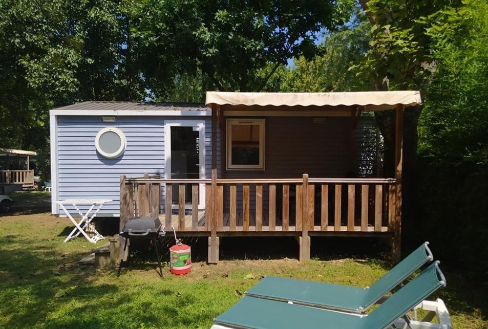 a tiny house with a porch and a deck at Mobile Homes by KelAir at Camping Sylvamar in Labenne