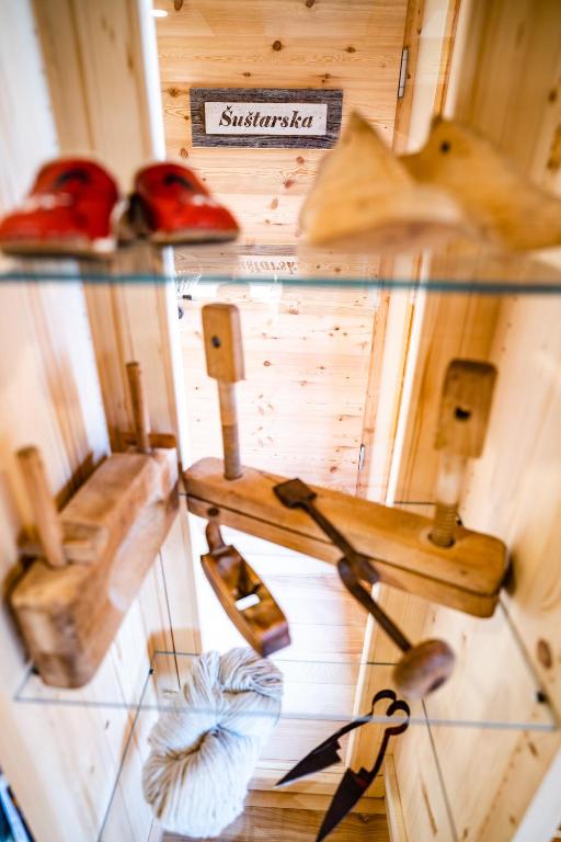 a display case with different types of tools on display at Tourist Farm Šenkova Domačija in Zgornje Jezersko