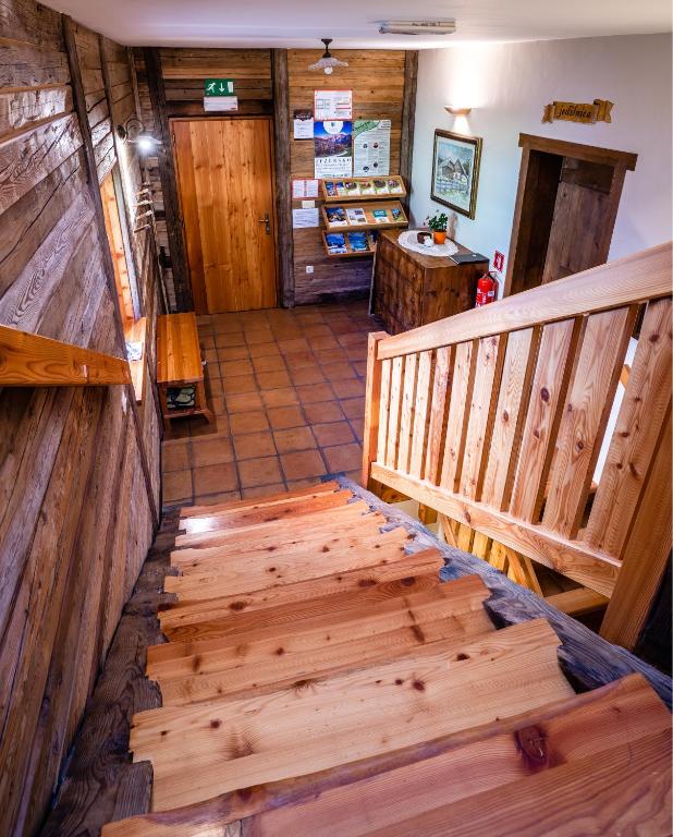 a hallway with wooden stairs in a store at Tourist Farm Šenkova Domačija in Zgornje Jezersko