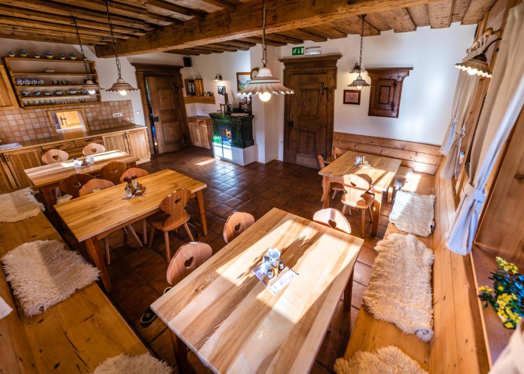 an overhead view of a restaurant with wooden tables and chairs at Tourist Farm Šenkova Domačija in Zgornje Jezersko