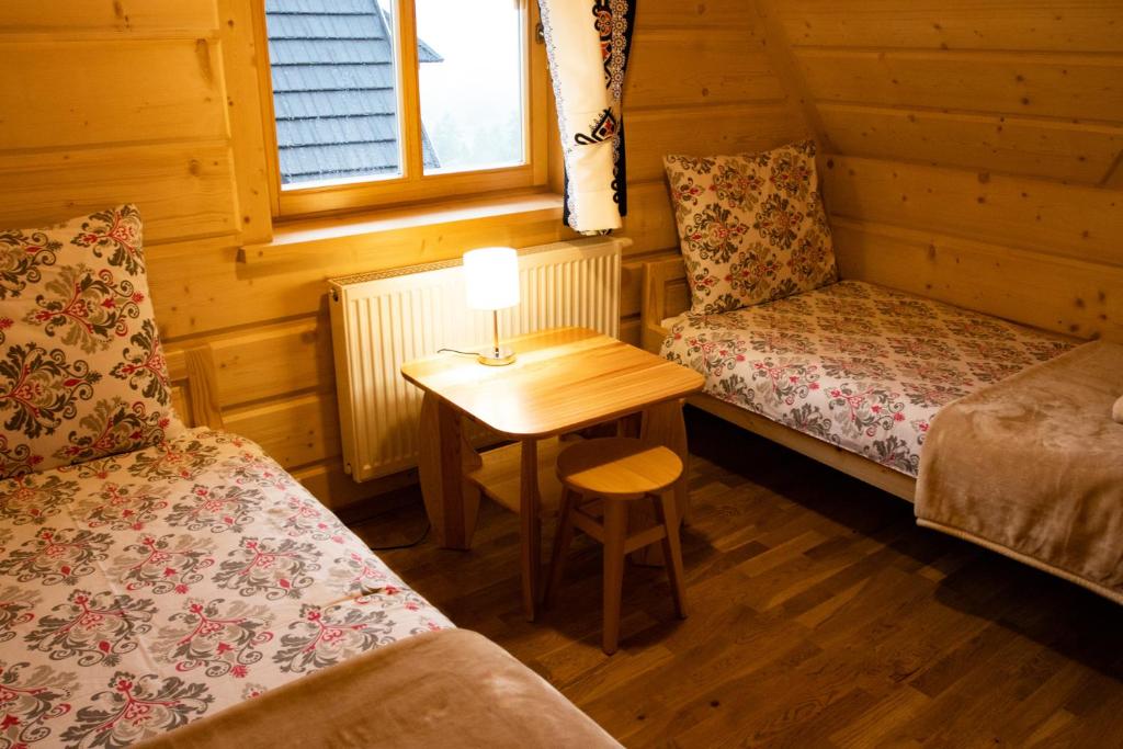 Postel nebo postele na pokoji v ubytování Domki Pod Tatrami