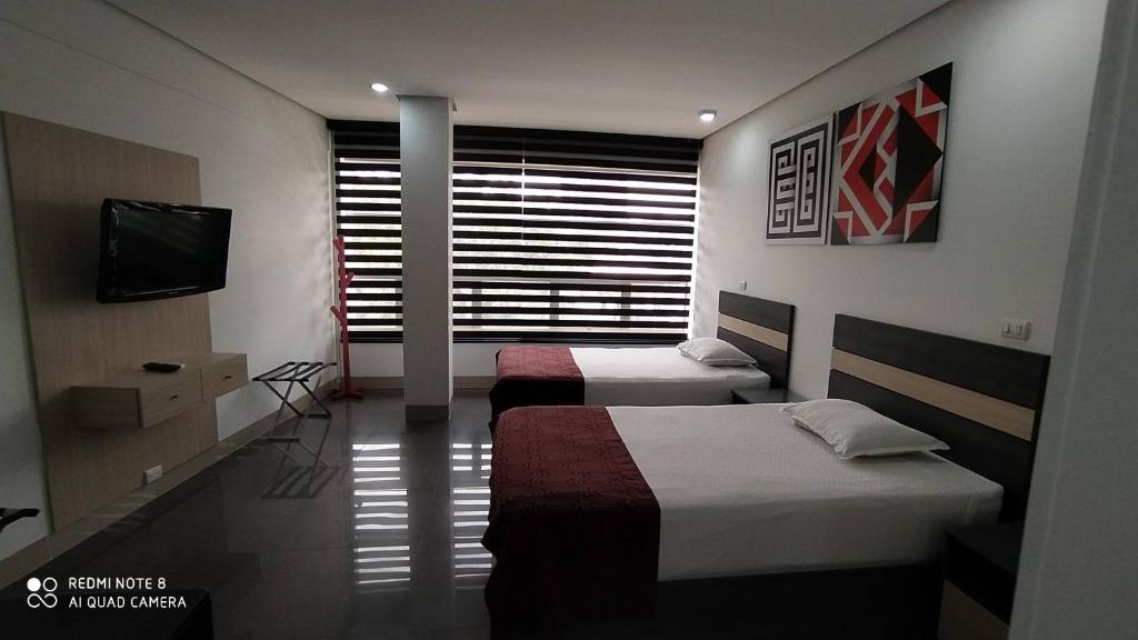 Postel nebo postele na pokoji v ubytování Hotel Merlott 70