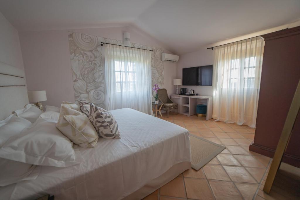 Postel nebo postele na pokoji v ubytování Hotel Borgo Smeraldo