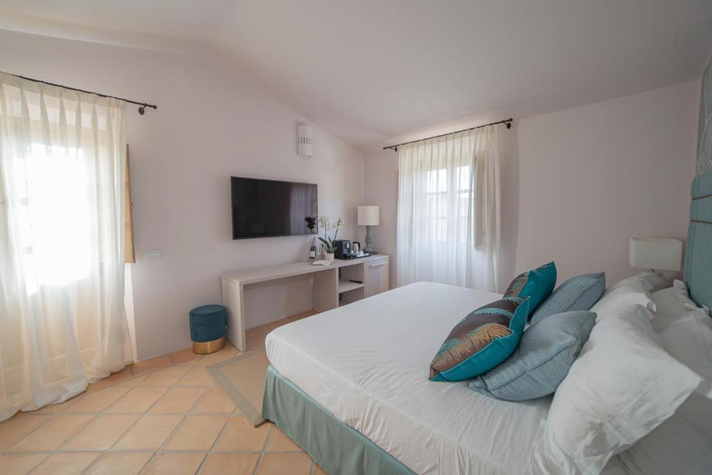 Postel nebo postele na pokoji v ubytování Hotel Borgo Smeraldo