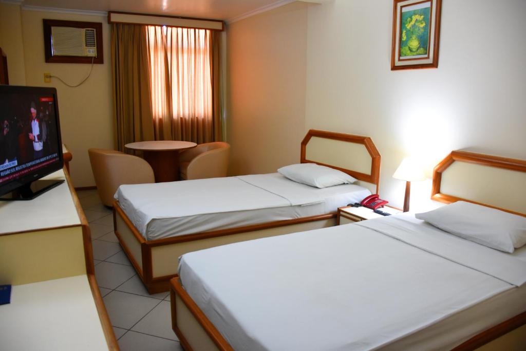 Ліжко або ліжка в номері Hotel Grão Para