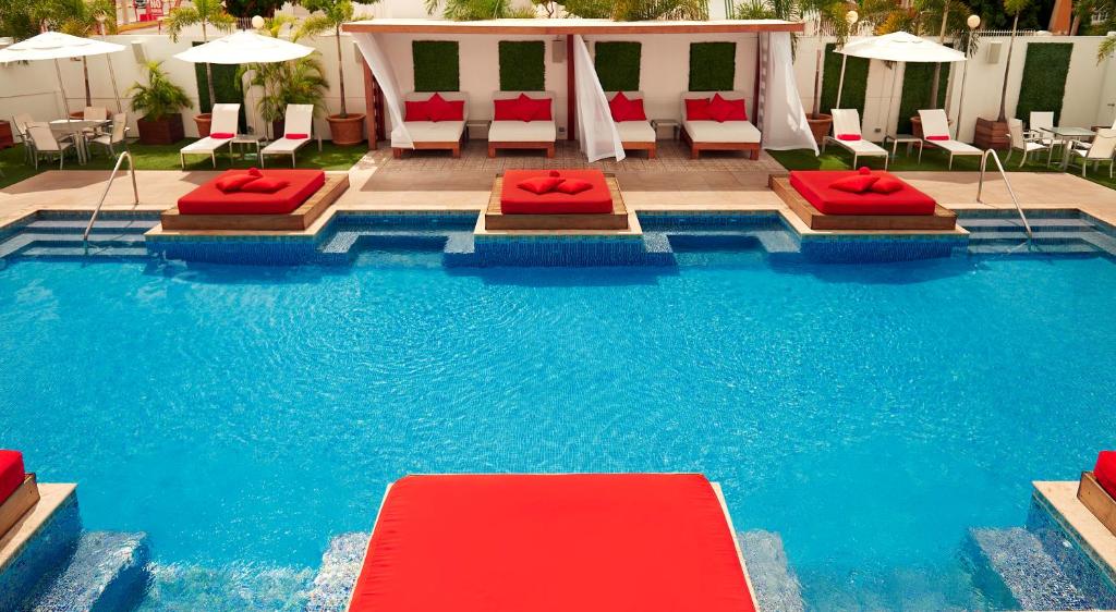 a pool with two beds and chairs in a hotel at Spanish Court Hotel - A Small Luxury Hotel in Kingston