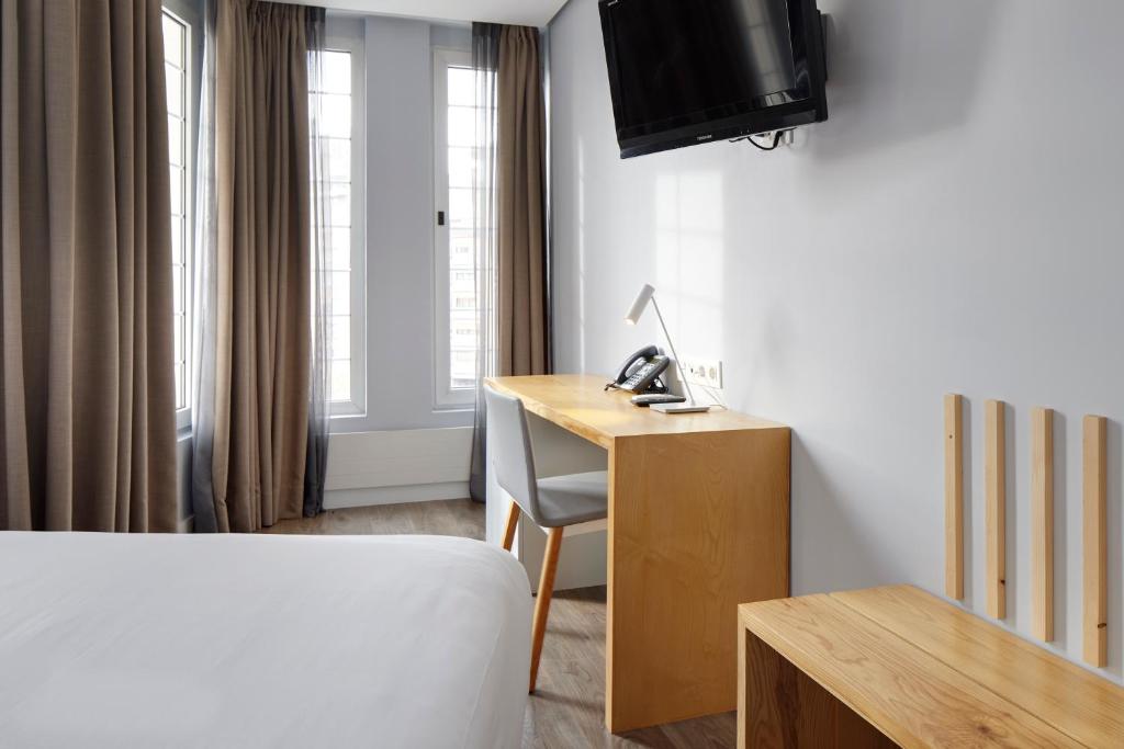 Postel nebo postele na pokoji v ubytování Hotel Avenida